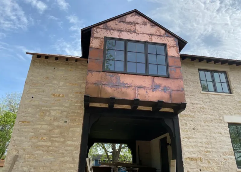 Copper metal panel facade on a stone building for Skylight Installation in Poinciana